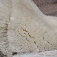 Sheepskin Half Pad *fair, clean, large bare spots, stains, clumpy, dingy, pills, mnr puckers, threads