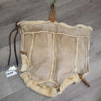 Sheepskin Saddle Seat Cover *fair/poor, converted jacket? stains, clumpy, holes, thins spots, rubber tubing
